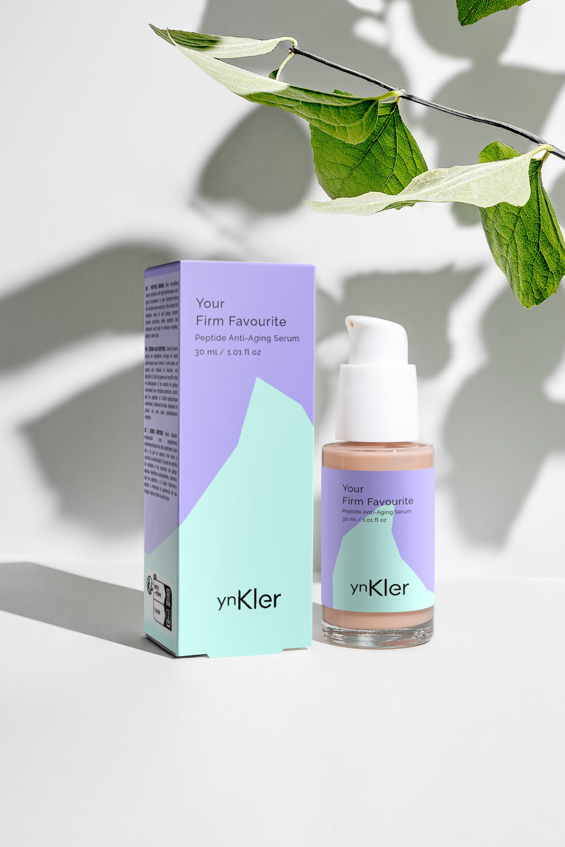 ynKler skincare serum bottle and packaging with green leaves in the background
