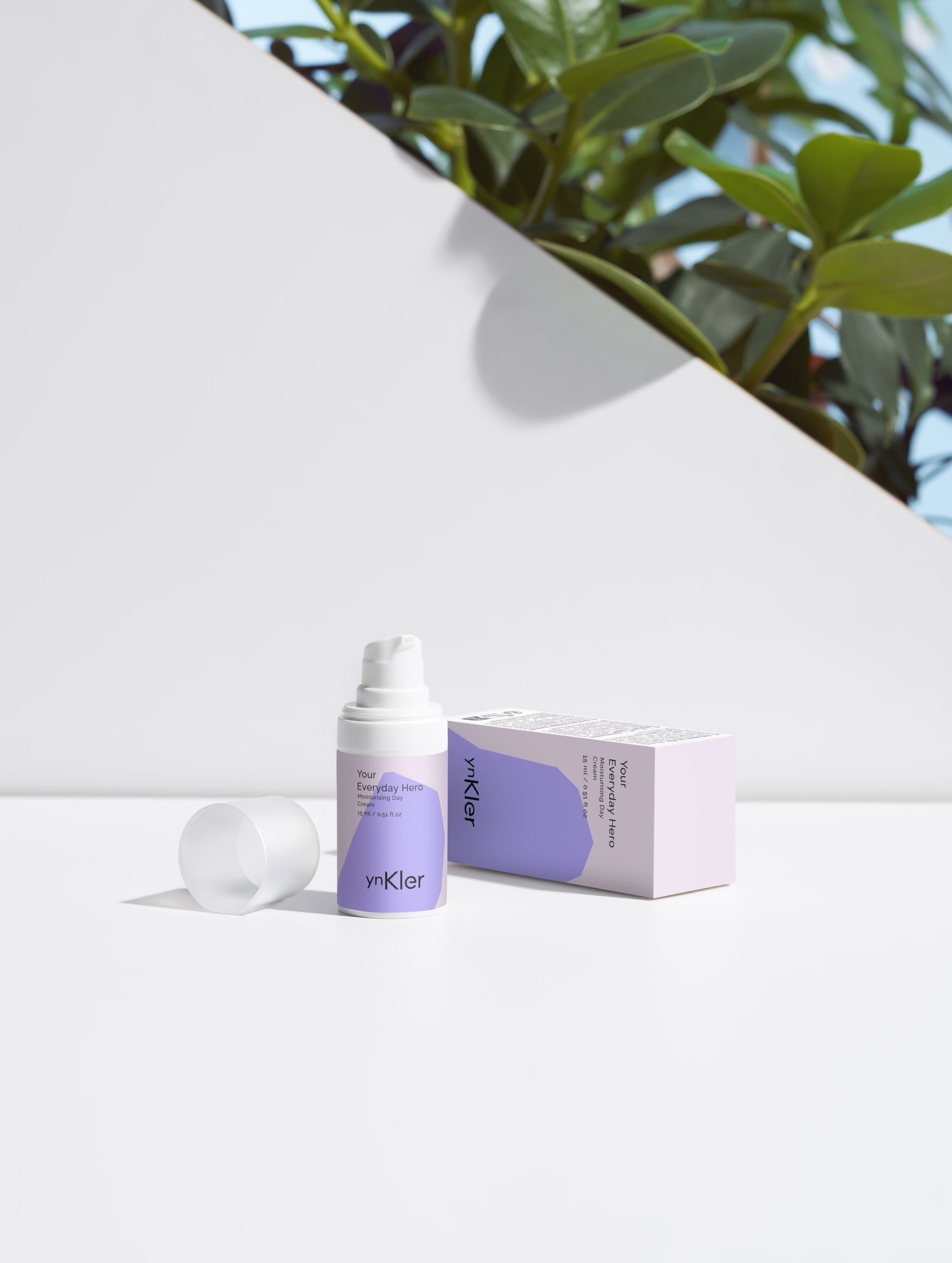 ynKler Skincare product with packaging on a white background with greenery